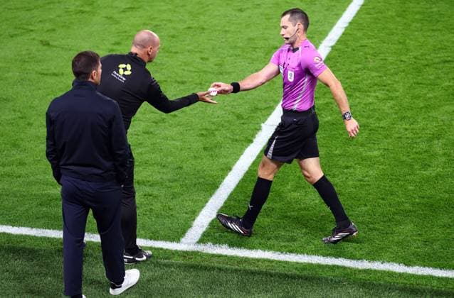 Referre Jarred Gillett hands fourth official Robert Madley an item that was thrown onto the pitch after the opening goal Chelsea v Leeds United, EFL Carabao Cup, Third Round, Football, Stamford Bridge, London, UK - 09 Sep 2026London Stamford Bridge United Kingdom EDITORIAL USE ONLY No use with unauthorised audio, video, data, fixture lists, club league logos or live services. Online in-match use limited to 120 images, no video emulation. No use in betting, games or single club league player publications. Copyright: xKieranxMcManus Shutterstockx 17140215ai