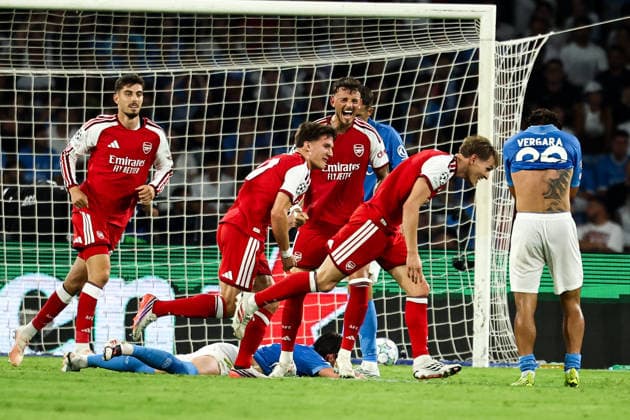 Martin Odegaard of Arsenal celebrates with team mates after scoring the goal of 0-1 during the UEFA Champions League 2026 2027 football match between SSC Napoli and Arsenal FC at Diego Armando Maradona stadium in Naples, (Italy), September 9, 2026. cesarexpurini