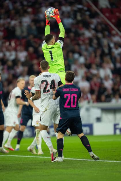 Fabian Bredlow of VfB Stuttgart catches the ball, Jeff Chabot of VfB Stuttgart and Peter Christiansen of Viking FK in aerial duel during UEFA Champions League - Matchday 1 season 26 27 game between Stuttgart and Viking (Ruslan Taran Ball Raw Images) Stuttgart MHP Arena Germany Copyright: xRuslanxTaranx RUS_STUTT-VIKING-0237