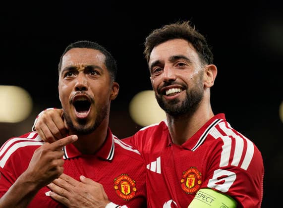 Manchester, England, 10th September 2026. Second goal scorer Bruno Fernandes of Manchester United, ManU (r) celebrates with Youri Tielemans of Manchester United (l) during the Manchester United vs Sabah UEFA Champions League match at Old Trafford, Manchester. Picture credit should read: Andrew Yates Sportimage EDITORIAL USE ONLY. No use with unauthorised audio, video, data, fixture lists, club league logos or live services. Online in-match use limited to 120 images, no video emulation. No use in betting, games or single club league player publications. SPI_034_AY_Man_Utd_Sabah SPI-4989-0034