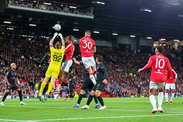 RECORD DATE NOT STATED 10th September 2026; Old Trafford, Manchester, England; UEFA Champions League Football, Manchester United, ManU versus Sabah; Stas Pokatilov of Sabah FK punches clear under pressure from Leny Yoro of Manchester United RogerxEvans