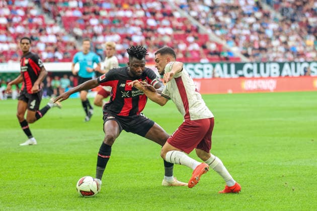 Arijon Ibrahimovic (FC Augsburg, 21) mit Ball, mit Edmond Tapsoba (Bayer 04 Leverkusen, 12), GER, FC Augsburg vs. Bayer 04 Leverkusen, Fussball, Bundesliga, 3. Spieltag, Saison 2026 2027, 12.09.2026, DFL DFB REGULATIONS PROHIBIT ANY USE OF PHOTOGRAPHS as IMAGE SEQUENCES and or QUASI-VIDEO, GER, FC Augsburg vs. Bayer 04 Leverkusen, Fussball, Bundesliga, 3. Spieltag, Saison 2026 2027, 12.09.2026 Augsburg *** Arijon Ibrahimovic of FC Augsburg, No. 21, with the ball, alongside Edmond Tapsoba of Bayer 04 Leverkusen, No. 12, GER, FC Augsburg vs. Bayer 04 Leverkusen, soccer, Bundesliga, Matchday 3, 2026–2027 season, September 12, 2026, DFL and DFB regulations prohibit any use of photographs as image sequences and or quasi-video, GER, FC Augsburg vs. Bayer 04 Leverkusen, soccer, Bundesliga, Matchday 3, 2026–2027 season, September 12, 2026, Augsburg Copyright: xEibner-Pressefoto JennixMaulx EP_JML
