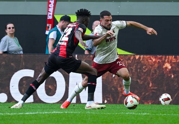 12.09.2026, xemx, Fussball 1.Bundesliga, FC Augsburg - Bayer 04 Leverkusen v.l. Edmond Tapsoba (Bayer 04 Leverkusen), Arijon Ibrahimovic (FC Augsburg) Zweikampf, Aktion, action, battle for the ball (DFL DFB REGULATIONS PROHIBIT ANY USE OF PHOTOGRAPHS as IMAGE SEQUENCES and or QUASI-VIDEO) Augsburg *** September 12, 2026, xemx, Soccer, Bundesliga 1, FC Augsburg vs. Bayer 04 Leverkusen, Edmond Tapsoba (Bayer 04 Leverkusen), Arijon Ibrahimovic, FC Augsburg, tackle, action, battle for the ball. DFL and DFB regulations prohibit any use of photographs as image sequences and or quasi-video. Augsburg