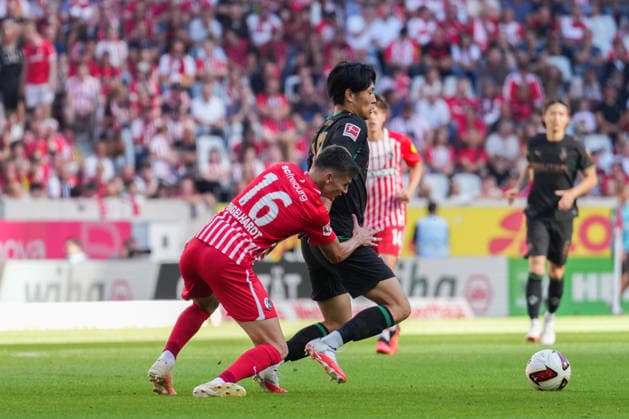 1. Bundesliga: SC Freiburg vs Borussia Mönchengladbach, 12.09.2026 Zweikampf zwischen Yannik Engelhardt (SC Freiburg, 16) und ShÅ«to Machino (Borussia Mönchengladbach, 18) 1. Bundesliga: SC Freiburg vs Borussia Mönchengladbach, Europa-Park-Stadion, 12.09.2026 DFB DFL REGULATIONS PROHIBIT ANY USE OF PHOTOGRAPHS AS IMAGE SEQUENCES AND OR QUASI-VIDEO. *** 1 Bundesliga: SC Freiburg vs. Borussia Mönchengladbach, September 12, 2026: Tackle between Yannik Engelhardt of SC Freiburg (16) and Shuto Machino of Borussia Mönchengladbach (18), Bundesliga Matchday 1: SC Freiburg vs. Borussia Mönchengladbach, Europa-Park Stadium, September 12, 2026 DFB and DFL regulations prohibit any use of photographs as image sequences and or quasi-video. Copyright: xBEAUTIFULxSPORTS Boscox