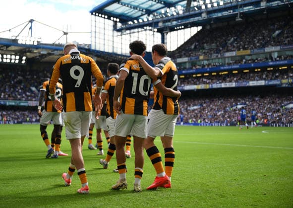 Chelsea v Hull City Premier League Hull City s Mohamed Belloumi is mobbed by team mates as he celebrates scoring their second goal during the Premier League match at Stamford Bridge, London 12 09 2026 UK Newspapers OUT Copyright: xDanielxHamburyx FIL-23926-0111
