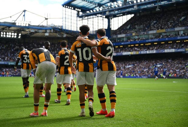 Chelsea v Hull City Premier League Hull City s Mohamed Belloumi is mobbed by team mates as he celebrates scoring their second goal during the Premier League match at Stamford Bridge, London 12 09 2026 UK Newspapers OUT Copyright: xDanielxHamburyx FIL-23926-0112