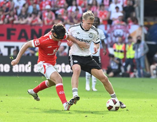 Fussball-Bundesliga - Saison 2026 2027 Mewa-Arena Mainz - 12.09.2026 1. FSV Mainz 05 (mz) - Eintracht Frankfurt (f) 1:3 Fabio GRUBER (mz), lio - Jonathan BURKARDT (Eintracht Frankfurt) DFL REGULATIONS PROHIBIT ANY USE OF PHOTOGRAPHS AS IMAGE SEQUENCES AND OR QUASI VIDEO EDITORIAL USE ONLY NATIONAL AND INTERNATIONAL NEWS AGENCIES OUT Fussball-Bundesliga - 1. FSV Mainz 05 *** Soccer Bundesliga 2026–2027 Season, Mewa Arena, Mainz, September 12, 2026, 1:00 p.m., FSV Mainz 05 vs. Eintracht Frankfurt, 1–3, Fabio GRUBER, mz, lio Jonathan BURKARDT Eintracht Frankfurt DFL REGULATIONS PROHIBIT ANY USE OF PHOTOGRAPHS AS IMAGE SEQUENCES AND OR QUASI-VIDEO; EDITORIAL USE ONLY; NATIONAL AND INTERNATIONAL NEWS AGENCIES OUT; German Bundesliga; 1. FSV Mainz 05
