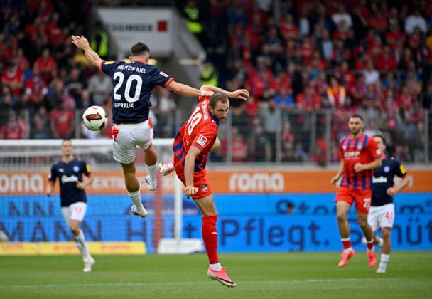 Kopfballduell Zweikampf Aktion Adrian Kapralik Holstein Kiel (20) gegen Jonas Foehrenbach 1. FC Heidenheim 1846 FCH (19) 1. FC Heidenheim 1846 FCH vs Holstein Kiel KSV 13.09.2026 DFL REGULATIONS PROHIBIT ANY USE OF PHOTOGRAPHS AS IMAGE SEQUENCES AND OR QUASI-VIDEO 1. FC Heidenheim 1846 FCH vs Holstein Kiel KSV