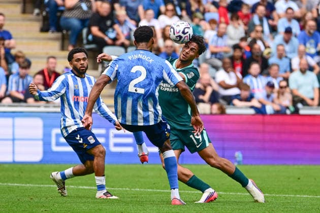 Coventry City v Brighton and Hove Albion, Premier League Brighton and Hove Albion forward Charalampos Kostoulas (19) heads the ball under pressure from Coventry City defender Ethan Pinnock (2) during the Premier League match between Coventry City and Brighton and Hove Albion at the Coventry Building Society Arena, Coventry, UK on 13 September 2026. Coventry Coventry Building Society Arena West Midlands UK Editorial use only DataCo restrictions apply See www.football-dataco.com , Copyright: xDennisxGoodwinx PSI-24865-0034