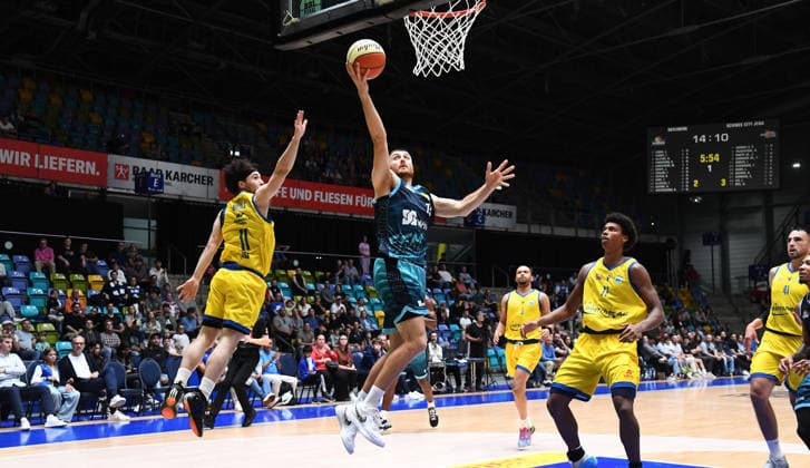13.09.2026, xokbx, Basketball Netto BBL Pokal, Skyliners Frankfurt - Sience City Jena v.l. Radii Caisin (Fraport Skyliners Frankfurt), Isaiah Moses (Medipolis SC Jena), Zweikampf, Duell, Sprung zum Korb, Wurf Frankfurt