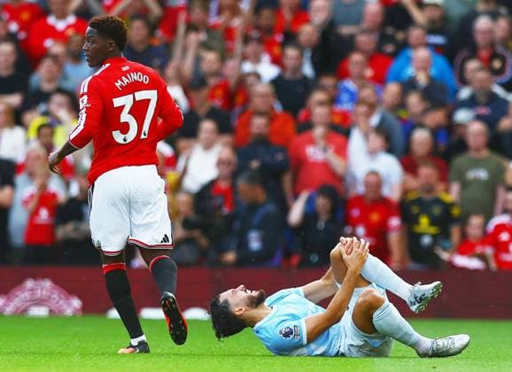 Rayan Cherki of Manchester City feels the pain from a knock Manchester United, ManU v Manchester City, Premier League, Football, Football, Old Trafford, Manchester, UK - 13 Sep 2026Manchester Old Trafford United Kingdom EDITORIAL USE ONLY No use with unauthorised audio, video, data, fixture lists, club league logos or live services. Online in-match use limited to 120 images, no video emulation. No use in betting, games or single club league player publications. Copyright: xMattxWest Shutterstockx 17144604y