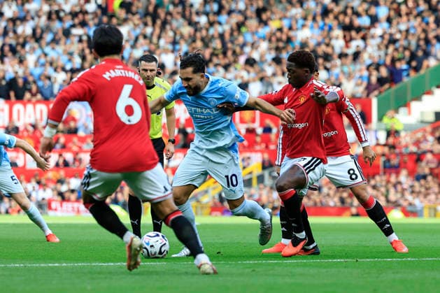 Manchester United, ManU v Manchester City, Premier League Rayan Cherki (10) of Manchester City and Kobbie Mainoo (37) of Manchester United challenge for the ball during the Premier League match between Manchester United and Manchester City at Old Trafford, Manchester, UK on 13 September 2026. Manchester Old Trafford Greater Manchester UK Editorial use only DataCo restrictions apply See www.football-dataco.com , Copyright: xConorxMolloyx PSI-24872-0030