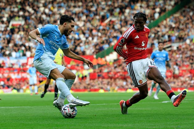 Manchester United, ManU v Manchester City, Premier League Rayan Cherki (10) of Manchester City tries to get past Patrick Dorgu (13) of Manchester United during the Premier League match between Manchester United and Manchester City at Old Trafford, Manchester, UK on 13 September 2026. Manchester Old Trafford Greater Manchester UK Editorial use only DataCo restrictions apply See www.football-dataco.com , Copyright: xConorxMolloyx PSI-24872-0037