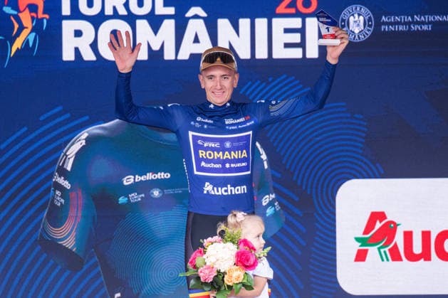 September 13, 2026, CYCLING TOUR OF ROMANIA, Stage 5 Bucharest Circuit 100 km, Bucuresti RAILEANU Cristian, from NATIONAL ROMANIA TEAM, Winner of the Best Romanian Cyclist classification (Blue Jersey) with the trophy and girl on stage.