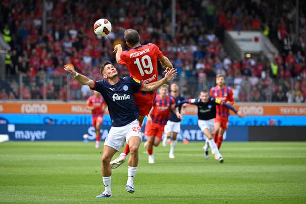 Kopfballduell Zweikampf Aktion Adrian Kapralik Holstein Kiel (20) gegen Jonas Foehrenbach 1. FC Heidenheim 1846 FCH (19) 1. FC Heidenheim 1846 FCH vs Holstein Kiel KSV 13.09.2026 DFL REGULATIONS PROHIBIT ANY USE OF PHOTOGRAPHS AS IMAGE SEQUENCES AND OR QUASI-VIDEO 1. FC Heidenheim 1846 FCH vs Holstein Kiel KSV