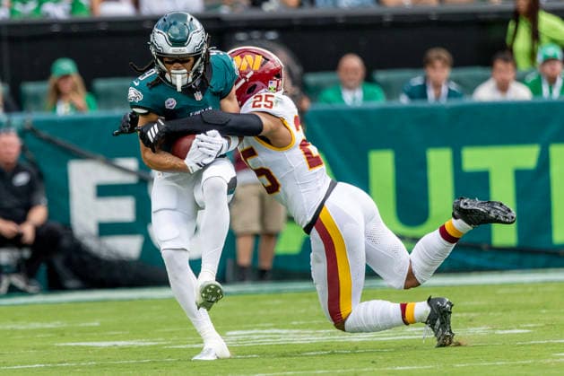 Philadelphia Eagles wide receiver Makai Lemon (9) is brought down by Washington Commanders safety Nick Cross (25) at the twenty five yard line for a second down in the first quarter of NFL, American Football Herren, USA action at Lincoln Financial Field in Philadelphia, Pennsylvania on Sunday, September 13, 2026.  PHI20260913005 LAURENCExKESTERSON