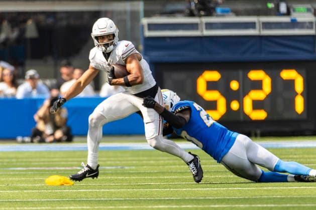 September 13, 2026, Inglewood, California, USA: Arizona Cardinals wide receiver Michael Wilson (14) is tackled by Los Angeles Chargers cornerback Cam Hart (20) during an NFL, American Football Herren, USA football game, in Inglewood, Calif. on Sunday 13, 2026. NHL, Eishockey Herren, USA 2026: Arizona Cardinals 26:14 LA Chargers - ZUMAc68_ 20260913_zaf_c68_032 Copyright: xRingoxChiux