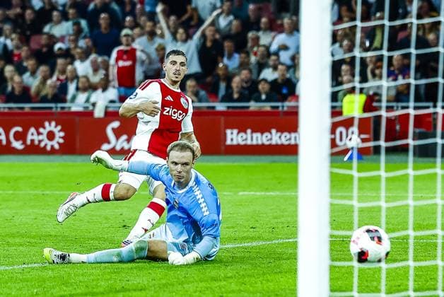 AMSTERDAM , 15-09-2026 , JohanCruijff ArenA , season 2026 2027 , Dutch Eredivisie football , match between Ajax and Willem II , picture shows Ajax player Oscar Gloukh scores the 4-0 , Willem II keeper Maxime Delanghe Ajax - Willem II  x207104073x Copyright: