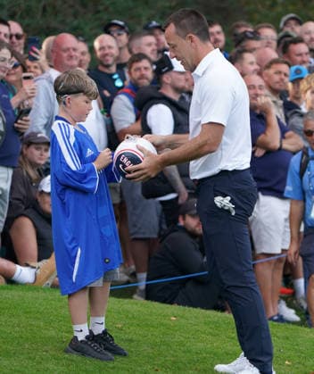 Golf - DP World Tour (European Tour) ˜Rolex Series™ - 2026 BMW PGA, Golf Herren Championship - Celebrity Pro-Am Round - West Course, Wentworth Club - Wednesday 16th September 2026 John Terry signs a Football for a young Chelsea supporter 