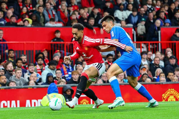 16th September 2026; Old Trafford, Manchester, England; Carabao Cup Football, Manchester United, ManU versus Brighton and Hove Albion; Matheus Cunha of Manchester United is under pressure from Diego Gomez of Brighton and Hove Albion RogerxEvans