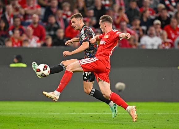 18.09.2026, Fussball Bundesliga 2026 2027, 4.Spieltag, FC Bayern München - 1.FC Union Berlin, in der Allianz-Arena München, v.l. Josip Stanisic (Bayern München) gegen Michael Aebischer (Union Berlin)