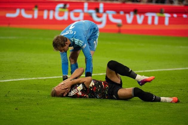 18.09.2026: Fußball: FC Bayern München - Union Berlin, 4. Spieltag der 1. Bundesliga in der Allianz Arena in München Harry Kane (FC Bayern Munchen, 9) verletzt am Boden nach einem Zweikampf. Frederik Rönnow (Union Berlin, 1) hilft. WICHTIGER HINWEIS: Gemäß den Vorgaben der DFL und des DFB ist es untersagt, in dem Stadion und oder vom Spiel angefertigte Fotoaufnahmen in Form von Sequenzbildern und oder videoähnlichen Fotostrecken zu verwerten bzw. verwerten zu lassen. Copyright: xJamesxZabelx