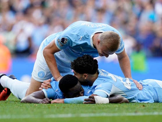 Manchester, England, 20th September 2026. Erling Haaland of Manchester City and Josko Gvardiol of Manchester City jump on top of Marc Guehi of Manchester City after his tackle led to the third goal during the Manchester City vs Sunderland Premier League match at the Etihad Stadium, Manchester. Picture credit should read: Andrew Yates Sportimage EDITORIAL USE ONLY. No use with unauthorised audio, video, data, fixture lists, club league logos or live services. Online in-match use limited to 120 images, no video emulation. No use in betting, games or single club league player publications. SPI_054_AY_ManCity_Sunderland SPI-5012-0054