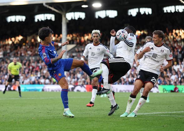 20th September 2026; Craven Cottage, London, England; Premier League Football, Fulham versus Manchester United, ManU Calvin Bassey of Fulham accidentally hand balls the ball from a shot by Lisandro Martinez of Manchester United with Referee Peter Banks watching from a distance JohnxPatrickxFletcher