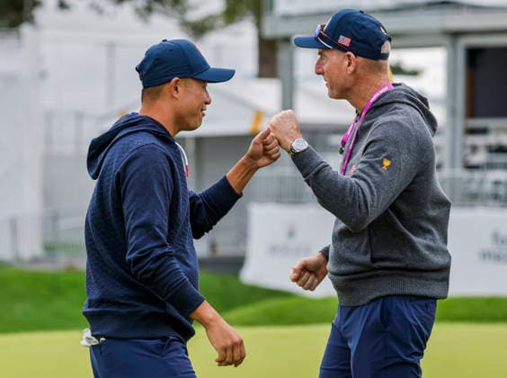 Colin Morikawa of the US (L) fist bumps with US team assistant captain Jim Furyk (R) during practice for the Presidents Cup golf tournament at Medinah Country Club in Medinah, Illinois on Monday, September 21, 2026. Competition between the USA and the International team begins on Thursday, September 24 with Four-Ball play.  MED20260922810 TANNENxMAURY