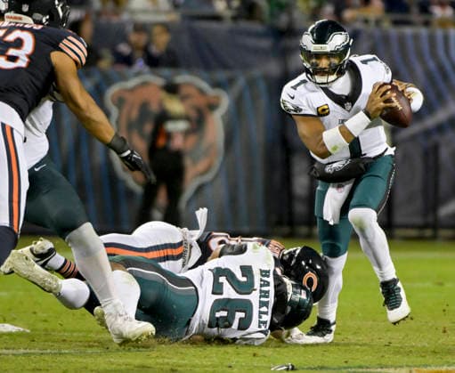 Philadelphia Eagles quarterback Jalen Hurts (1) avoids the tackle from Chicago Bears linebacker D Marco Jackson (48) in the third quarter at Soldier Field in Chicago on Monday, September 28, 2026. Bears defeated the Eagles 27-7.  CHI20260928115 MARKxBLACK