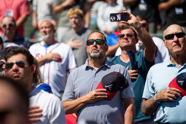 Fans stand for the National Anthem during the pregame against the Philadelphia Phillies in game one of the MLB, Baseball Herren, USA National League Wild Card round at Truist Park on Tuesday, September 29, 2026 in Atlanta, Georgia.  ATL20260928105 JULIANxALEXANDER