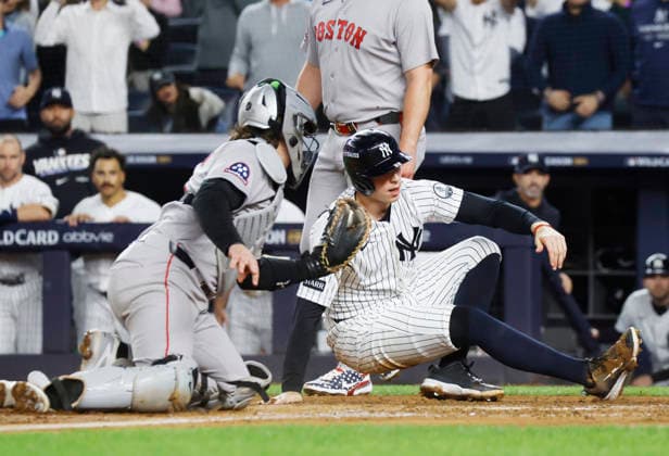 New York Yankees Ben Rice (22) is tagged out at home by Boston Red Sox catcher Adley Rutschman (31) on a throw from Red Sox left fielder Nate Eaton in the fifth inning of an MLB, Baseball Herren, USA American League Wild Card game at Yankee Stadium in New York City, on Wednesday, September 30, 2026.  NYP20260930715 JOHNxANGELILLO