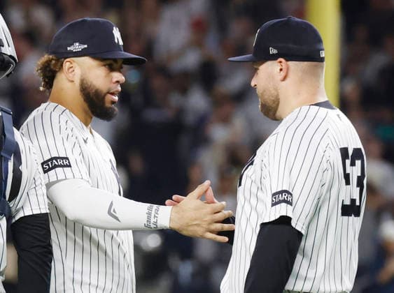 New York Yankees closing pitcher David Bednar (R) celebrates with teammate Luis Garcia Jr. after the Yankees defeated the Boston Red Sox 9-2 to win their MLB, Baseball Herren, USA American League Wild Card series at Yankee Stadium in New York City, on Wednesday, September 30, 2026. The Yankees advance to play the Tampa Bay Rays in the Division Championship.  NYP20260930732 JOHNxANGELILLO