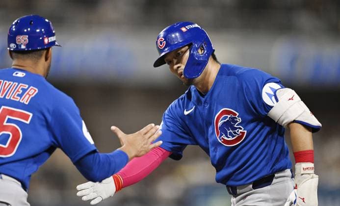 Baseball: Wild Card Series between Cubs and Padres Chicago Cubs right fielder Seiya Suzuki (R) is greeted by first base coach Jose Javier after his single in the fourth inning of Game 2 of the best-of-three National League Wild Card Series against the San Diego Padres at Petco Park in San Diego, California, on Sept. 30, 2026.  A14AA0005629562P