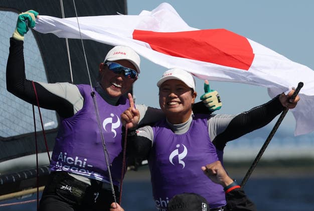 (261001) -- GAMAGORI, Oct. 1, 2026 -- Tanaka Misaki (R) and Nagamatsu Sera of Japan celebrate after winning the Women s Skiff Opening Series Race of Sailing at the 20th Asian Games Aichi-Nagoya 2026 in Gamagori of Aichi Prefecture, Japan, Oct. 1, 2026. ) (SP)JAPAN-GAMAGORI-ASIAN GAMES-SAILING-WOMEN S SKIFF DengxHua 