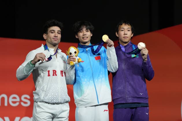 (261001) -- NAGOYA, Oct. 1, 2026 -- Gold medalist Chu Shouhong (C) of China, silver medalist Reza Ali Pour Shenazandi Fard (L) of Iran and Damir Toktarov of Kazakhstan pose during the awarding ceremony for the men s speed 4 final of climbing at the 20th Asian Games Aichi-Nagoya 2026 in Nagoya, Japan, Oct. 1, 2026. ) (SP)JAPAN-NAGOYA-ASIAN GAMES-SPORT CLIMBING-MEN-SPEED 4 FINAL JiaxYuchen 