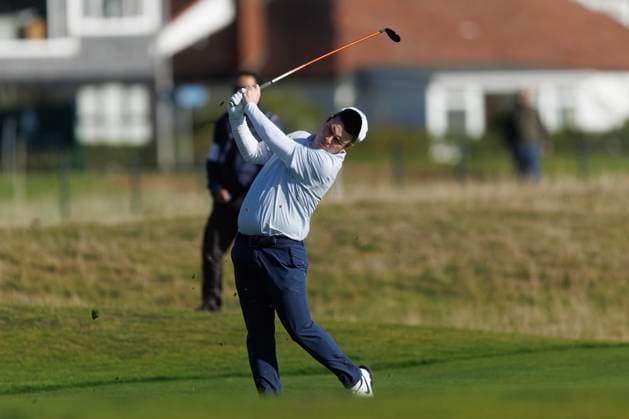 1st October 2026; Carnoustie Golf Links, Carnoustie, Angus, Scotland; DP World Tour Golf, Alfred Dunhill Links Championship, Day 1; Robert Macintyre of Scotland loses his hat in the wind as he plays a shot from the fairway on the seventeenth hole DavidxYoung
