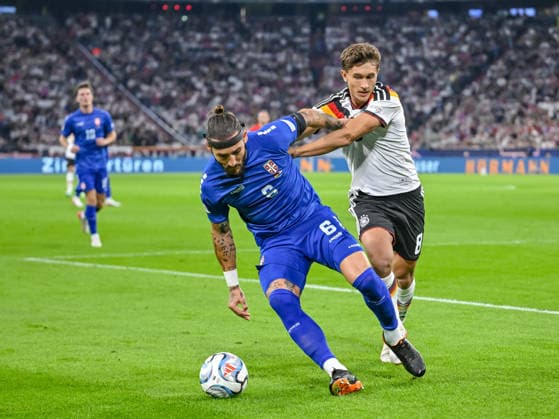 Nemanja Gudelj (Serbia) and Tom Bischof (Germany) battle for the ball during the UEFA Nations League 2026 27 group phase match between Germany and Serbia at Allianz Arena on October 1, 2026 in Munich, Germany. (Photo by Harry Langer DeFodi Images) -