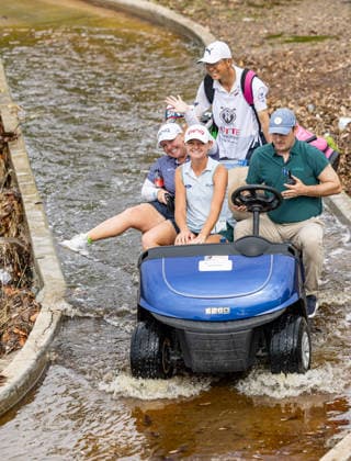 October 1, 2026, Honolulu, Hawaii, USA: HAILEE COOPER (left) and LANEY FRYE (middle) ride a golf cart across a flooded foot bridge next to the 6th tee at the 2026 Lotte Championship at Hoakalei Country Club, Ewa Beach, Hawaii, USA. Even though Hurricane Nolo had already passed Hawaii, its outer bands dropped bouts of heavy rain during Round 1. Honolulu USA - ZUMAm310 20261001_zsp_m310_005 Copyright: xElliotxMilesx