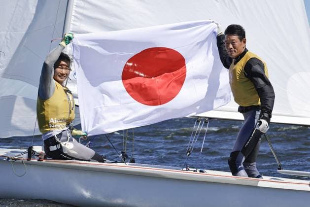 Aichi-Nagoya Asian Games: Sailing Japanese sailors Yurie Seki (L) and Tetsuya Isozaki celebrate after winning the Aichi-Nagoya Asian Games mixed dinghy gold off Kaiyoh Yacht Harbor in Gamagori in Aichi Prefecture, central Japan, on Oct. 2, 2026.  A14AA0005629735P