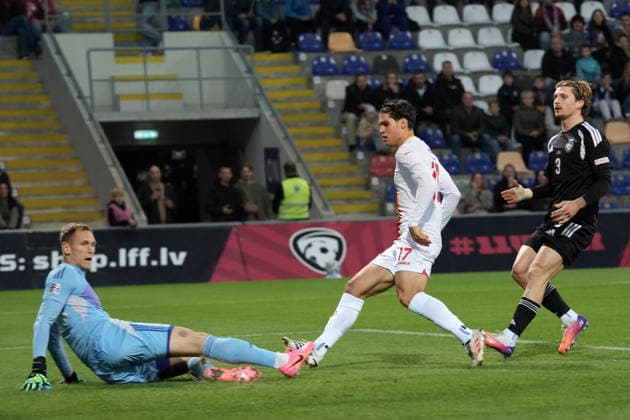 Vasilije Adzic (17) of Montenegro, centre, scores his first goal against goalie Rihards Matrevics (23) of Latvia during UEFA Nations League Group C2 football game between Latvia and Montenegro in Riga, Latvia, Fri, Oct. 2, 2026. Riga Latvia Copyright: xRomanxKoksarovx RKV09691.JPG