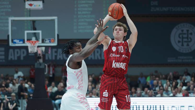 Im Bild: v.li. John-Michael Wright (Telekom Baskets Bonn, 1) gegen Calvin Wishart (Wuerzburg Baskets, 10) mit dem Dreipunktewurf 02.10.2026, Fitness First Wuerzburg Baskets vs. Telekom Baskets Bonn, easyCredit BBL, 4. Spieltag, Deutschland, 97072, tectake-Arena Wuerzburg, Copyright: HMBxMedia xJulienxBecker
