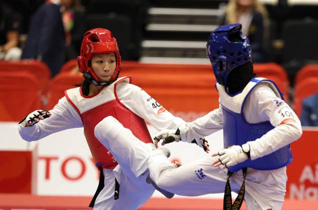 (261003) -- TOYOHASHI, Oct. 3, 2026 -- Zhang Chuling (L) of China competes with Fadia Khirfan of Jordan during the women -57kg gold medal contest of taekwondo at the 20th Asian Games Aichi-Nagoya 2026 in Toyohashi of Aichi Prefecture, Japan, Oct. 3, 2026. ) (SP)JAPAN-TOYOHASHI-ASIAN GAMES-TAEKWONDO-WOMEN S -57KG WangxFei 