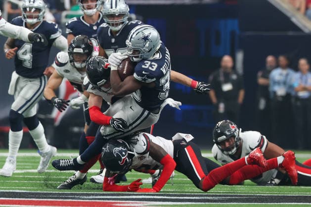 HOUSTON, TX - OCTOBER 04: Running back Javonte Williams 33 of the Dallas Cowboys is tackled by safety Reed Blankenship 6 of the Houston Texans and safety Calen Bullock 2 of the Houston Texans during the NFL, American Football Herren, USA football game between the Houston Texans and Dallas Cowboys on October 4, 2026, at Reliant Stadium in Houston, TX. (Photo by David Buono Icon Sportswire) NFL: OCT 04 Cowboys at Texans EDITORIAL USE ONLY Icon241004024