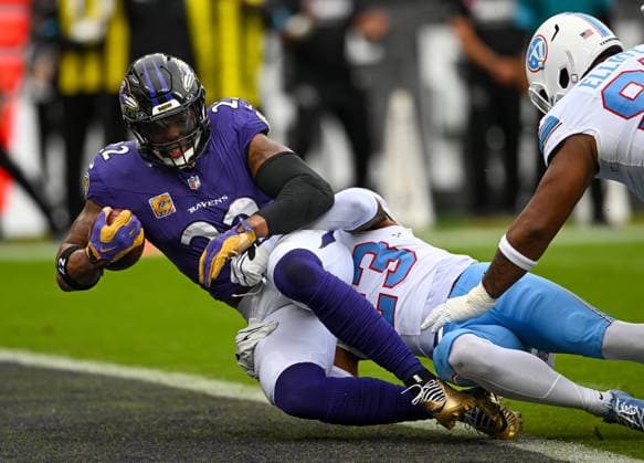 Baltimore Ravens running back Derrick Henry (22) scores on a five yard touchdown run against Tennessee Titans safety Kevin Winston Jr. (23) during the first quarter at M&T Bank Stadium in Baltimore, Maryland, on Sunday, October 4, 2026.  BAL20261004101 DAVIDxTULIS