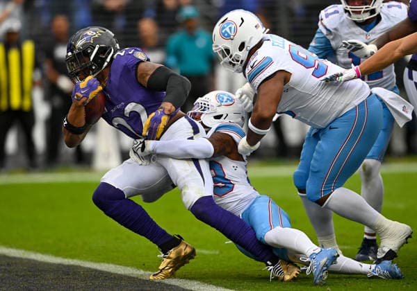 Baltimore Ravens running back Derrick Henry (22) scores on a five yard touchdown run against Tennessee Titans safety Kevin Winston Jr. (23) and defensive tackle Jordan Elliott (95) during the first quarter at M&T Bank Stadium in Baltimore, Maryland, on Sunday, October 4, 2026.  BAL20261004109 DAVIDxTULIS