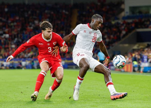 Cardiff, Wales, 4th October 2026. Mohamed Daramy of Denmark holds off a challenge from Neco Williams of Wales during the Wales vs Denmark UEFA Nations League match at the Cardiff City Stadium, Cardiff. Picture credit should read: Cody Froggatt Sportimage EDITORIAL USE ONLY. No use with unauthorised audio, video, data, fixture lists, club league logos or live services. Online in-match use limited to 120 images, no video emulation. No use in betting, games or single club league player publications. SPI_028_CF_WALES_V_DENMARK SPI-5051-0028
