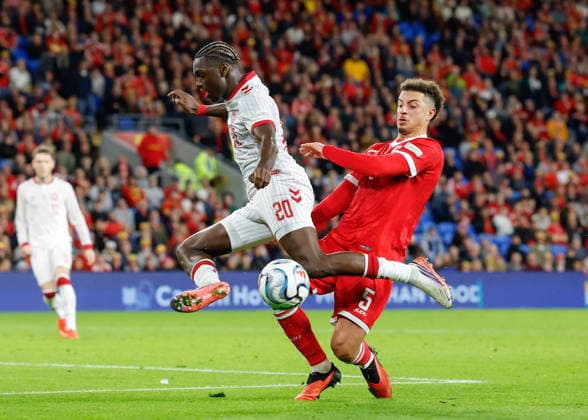 Cardiff, Wales, 4th October 2026. Ethan Ampadu of Wales tackles Mohamed Daramy of Denmark during the Wales vs Denmark UEFA Nations League match at the Cardiff City Stadium, Cardiff. Picture credit should read: Cody Froggatt Sportimage EDITORIAL USE ONLY. No use with unauthorised audio, video, data, fixture lists, club league logos or live services. Online in-match use limited to 120 images, no video emulation. No use in betting, games or single club league player publications. SPI_029_CF_WALES_V_DENMARK SPI-5051-0029