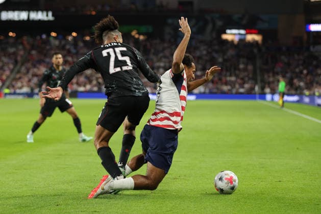 SAINT PAUL, MN - OCTOBER 06: Canada™s Nathan Saliba (25) fouls United States Tyler Adams (4) during the second half of the men™s friendly match between the U.S. national team, Nationalteam and Canada™s national team on October 6th, 2026, at Allianz Field in Saint Paul, MN. (Photo by Bailey Hillesheim Icon Sportswire) SOCCER: OCT 06 USA vs Canada EDITORIAL USE ONLY Icon20261006021