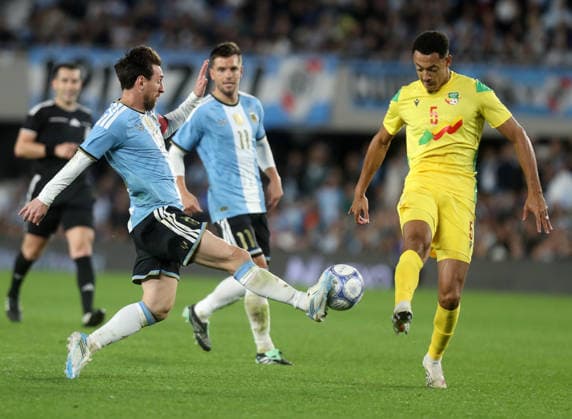 (261007) -- BUENOS AIRES, Oct. 7, 2026 -- Lionel Messi (front L) of Argentina vies for the ball with Yohan Roche of Benin during a football friendly match between Argentina and Benin at the Monumental Stadium in Buenos Aires, capital of Argentina, on Oct. 6, 2026. The match marked Lionel Messi s final appearance for the Argentina national football team. (Photo by Xinhua) (SP)ARGENTINA-BUENOS AIRES-FOOTBALL-FRIENDLY MATCH-ARGENTINA VS BENIN MartinxZabala 